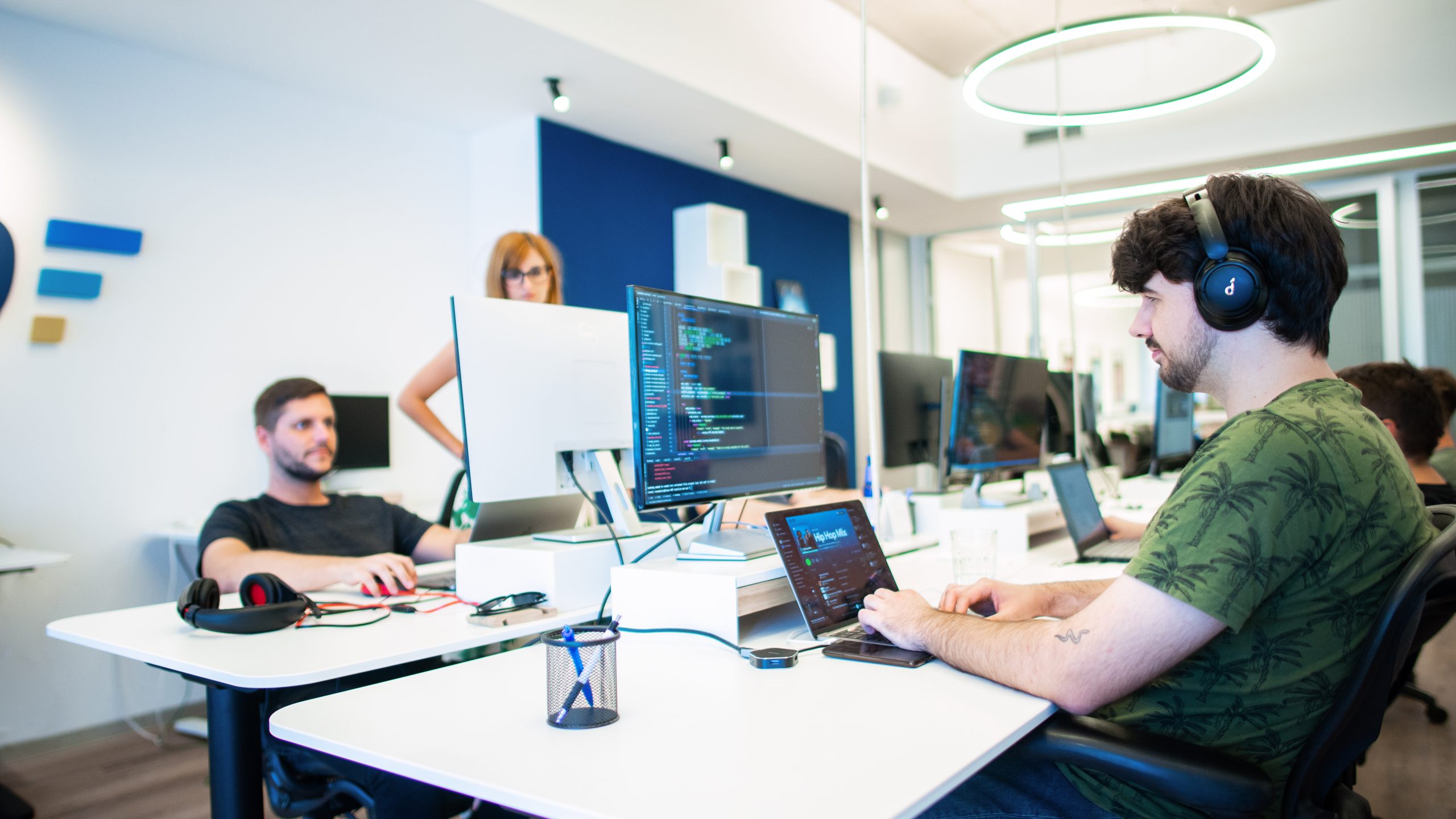 Programmers at the desk, programming on the laptop in the tech company.